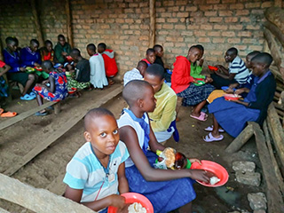 Feeding Uganda children.